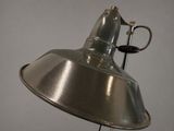a metal lamp that is on a stand on a table