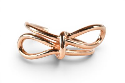 an image of a gold ring with a knot on it