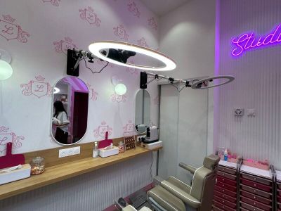 a hair salon with a mirror and chairs in the room