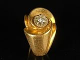 an image of a gold ring with a diamond in the center