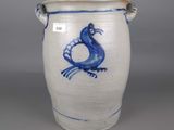 a blue and white vase with a bird on it
