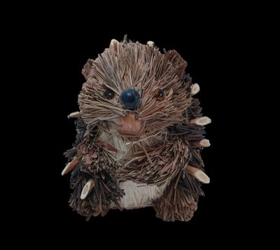 a small stuffed animal that is sitting on a black surface