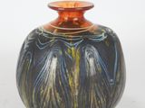 a vase that is sitting on a white surface
