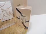 two boxes of perfume sitting on a table next to each other