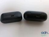 two black ear buds sitting next to each other on top of a table