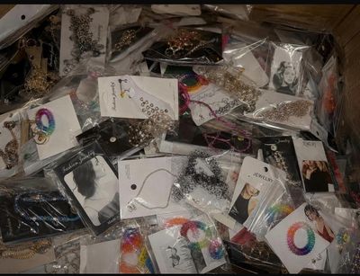 a box filled with lots of jewelry and other items