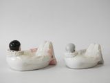 two figurines of a man and a woman in a boat