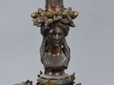 an image of a lamp with a statue on top of it