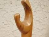 a wooden sculpture that is on a wooden table