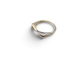 a close up of a gold ring on a white surface