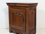an old wooden cabinet sitting on top of a floor next to a white wall