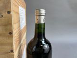 a bottle of wine sitting next to a wooden box
