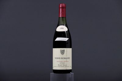 a bottle of red wine sitting on top of a table