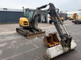 a small excavator that is sitting in the parking lot