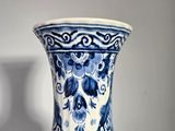 a blue and white vase sitting on a table
