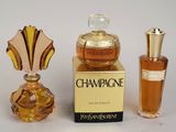 two bottles of perfume sitting next to each other on a table