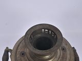 a small metal object that is on a white surface