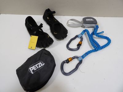 a bag, a pair of shoes, a lanyard, and a pair of shoes on a table