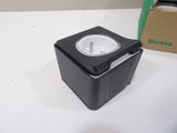 a small black box with a white plug in it
