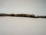 a long stick made out of rocks on a white surface