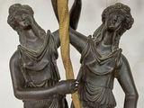 a statue of two people holding a rope in their hands
