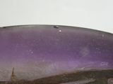 a close up of a purple and black object on a table