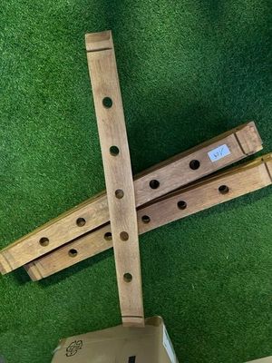 a wooden instrument that is laying on a green carpet