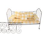yellow and white checkered day bed with pillows on top of it