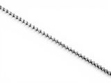 a close up of a chain with a diamond on it