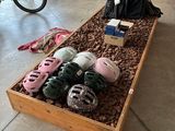 many pairs of shoes in a wooden box on the floor