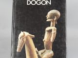the book is sitting on a table with a wooden horse