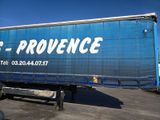 a large blue truck that is parked in a parking lot