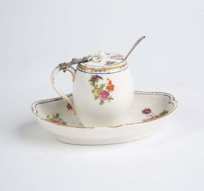 a tea cup and saucer with a spoon on a saucer