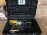 a black tool box with a cordless drill in it on a wooden table