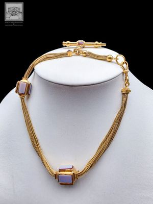 a close up of a necklace on a mannequin mannequin