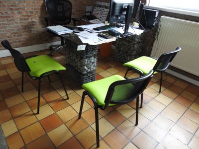 a desk with two chairs and a computer on it