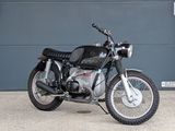 a black motorcycle parked in front of a garage door
