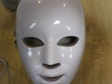 a white mask that is on a wooden table