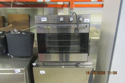 a stainless steel oven sitting on top of a metal counter
