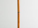 an old wooden flute with a wooden stick sticking out of it