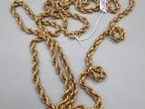a close up of a gold chain with a tag on it