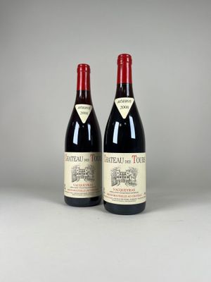 two bottles of red wine sitting next to each other on a table