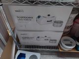 a box that is sitting on a shelf next to a blender
