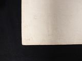 a close up of a piece of paper on a black surface