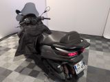a motorcycle that is parked on a checkered floor