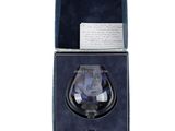 an open box with a glass in it on a white surface