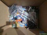 a cardboard box filled with electronic equipment and other items