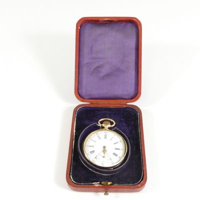 a small box with a pocket watch inside of it