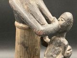 an image of a statue of a man holding a baby