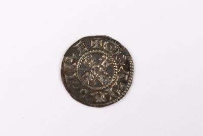 a close up of a coin on a white surface